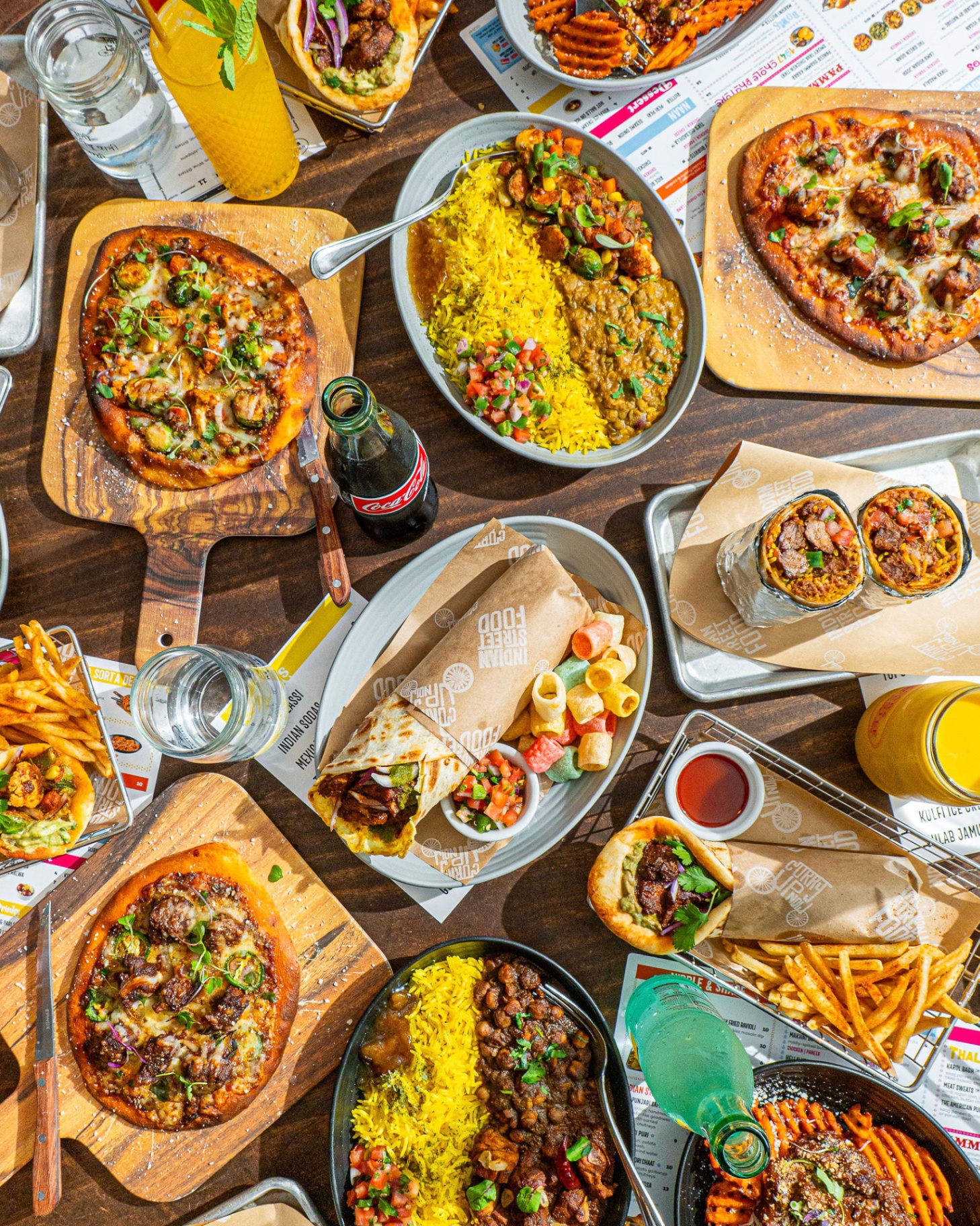 Indian street food spread - burritos, naan, bowls